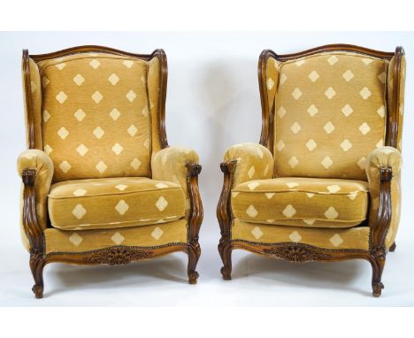 A French style salon suite comprising a two seater sofa and two chairs, upholstered in gold fabric, frames carved with shell 