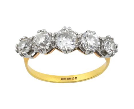 An 18 Carat Gold Diamond Five Stone Ringthe graduated old cut diamonds in white double claw settings, to a yellow tapered sho