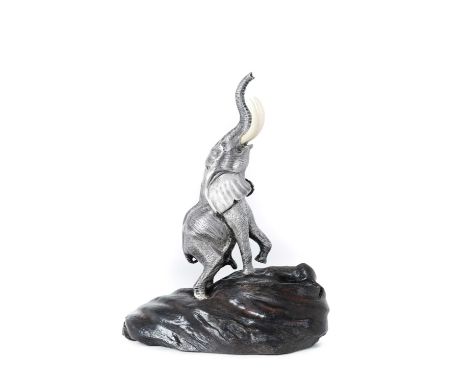 A Zimbabwean Silver Model of a Bull Elephant Reaching,  by Patrick Mavros, Harare, Circa 1993  realistically modelled and wit