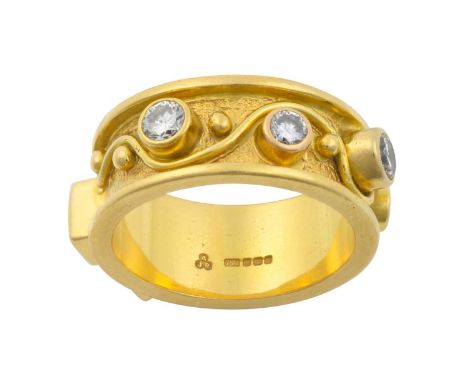 An 18 Carat Gold Diamond Ringthe yellow textured band inset with four vari-sized round brilliant cut diamonds, two princess c