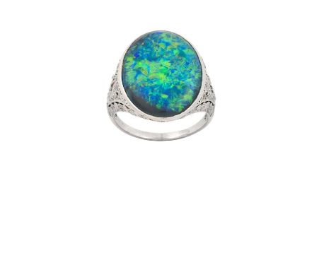 A Black Opal and Diamond Ringthe oval black opal in a white rubbed over setting, to pierced shoulders and gallery set through