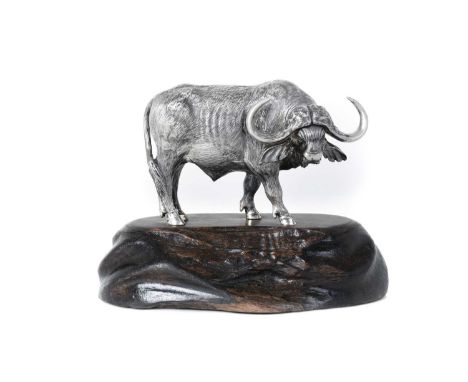 A Zimbabwean Silver Model of a Buffalo Bull,  by Patrick Mavros, Harare, Circa 1994 realistically modelled, on blackwood base