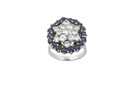 A Sapphire and Diamond Cluster Ringthe raised central round brilliant cut diamond within a double stepped border of round bri