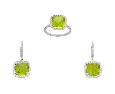 A Peridot and Diamond Cluster Ring and A Pair of Matching Drop Earringsthe cushion cut peridot within an openwork border of r