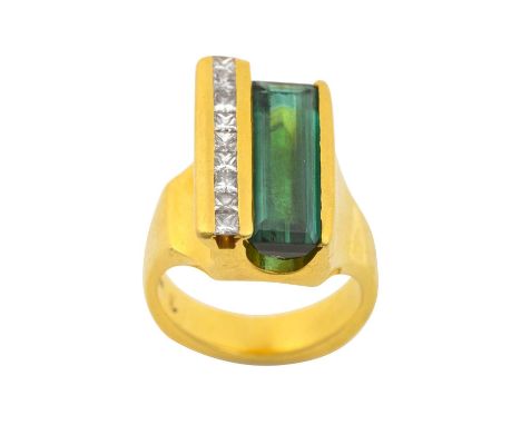 A Green Tourmaline and Diamond Ringthe rectangular step cut green tourmaline in a yellow channel setting, with a row of princ