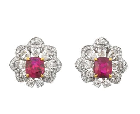 A Pair of Ruby and Diamond Cluster Earrings the cushion cut rubies in yellow claw settings, within borders of round brilliant