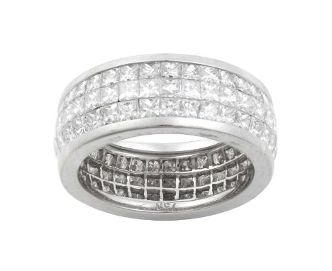A Diamond Eternity Ringthree rows of princess cut diamonds in a white channel setting, total estimated diamond weight 5.25 ca