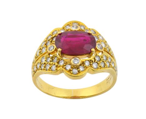 A Ruby and Diamond Ringthe oval cut ruby in a yellow claw setting, with round brilliant cut diamonds at four points in rubbed