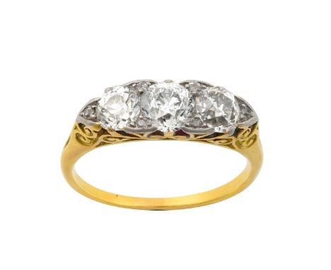 A Victorian Diamond Three Stone Ringthe old cut diamonds with rose cut diamond accents, in white claw settings, to a yellow s