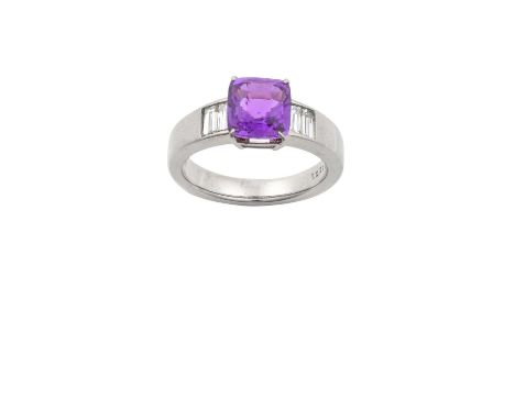 A Purple Sapphire and Diamond Ringthe cushion cut purple sapphire in a white claw setting, to pairs of baguette cut diamond s