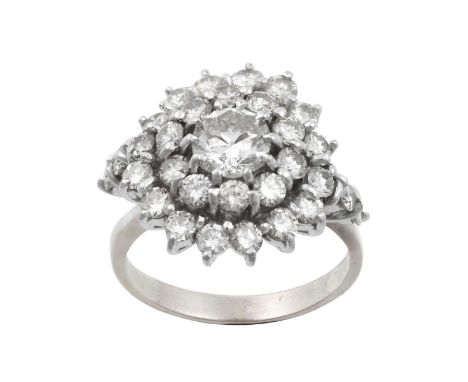 A Diamond Cluster Ringthe central round brilliant cut diamond within a double stepped border of smaller round brilliant cut d