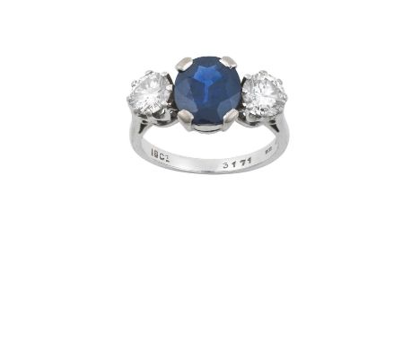 A Sapphire and Diamond Three Stone Ringthe oval cut sapphire flanked by round brilliant cut diamonds, in white claw settings,