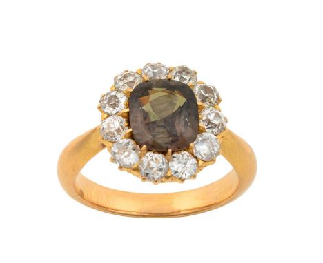 An Alexandrite and Diamond Cluster Ringthe cushion cut alexandrite within a border of old cut diamonds, in yellow claw settin