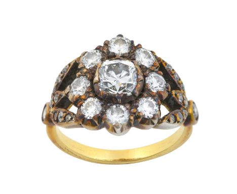 A Diamond Cluster Ringthe central raised old cut diamond within a border of smaller old cut and round brilliant cut diamonds,