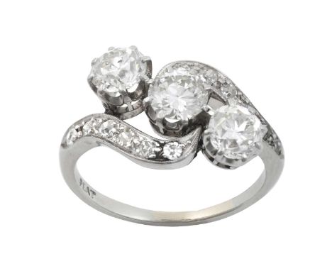 A Diamond Three Stone Twist Ringthe central round brilliant cut diamond flanked by old cut diamonds, in white claw settings, 