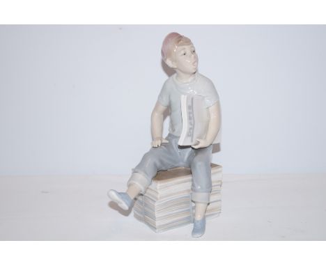 Nao figure of a boy holding newspaper Height 24 cm