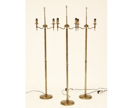 Three contemporary brass twin branch floor standing standard lamps, each 160cm high,* This lot will be sold with VAT on the h