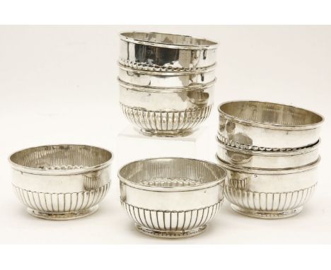 A set of eight continental white metal bowls of half gadrooned form, and on a short foot, each 11.5cm diameter x 6cm high, 41