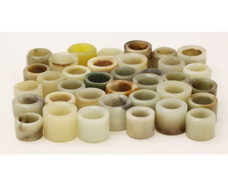 A large quantity of approximately 35 jade and other hardstone archer's rings
