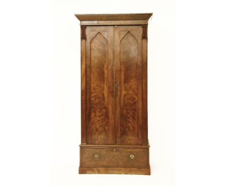 A William IV Mahogany hall cupboard, the arching panelled doors over single drawer and on plinth base, 98cm x 51.5cm x 202cm