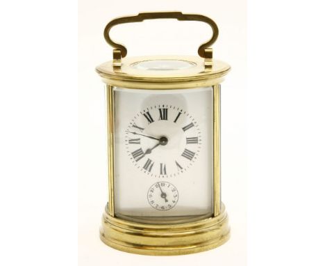 A 20th century lacquered brass circular carriage alarm clock, the looped handle over platform escapement, the bowed white ena