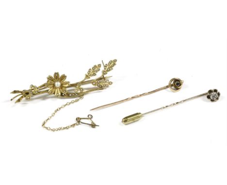 A 9ct gold split pearl floral spray bar brooch (pin not gold), a gold single stone sapphire stick pin, marked 15ct, and a gol