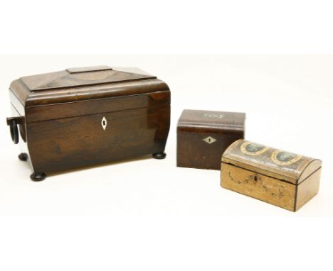 A Victorian rosewood tea caddy, of sarcophagus form and with wooden ring handles to either end, the lid opening to reveal two