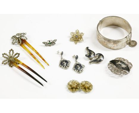 A collection of items to include a sterling silver hinge bangle, with gold faced swallows, flowerheads and shamrock to a brig