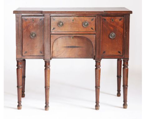 A small Regency mahogany breakfront sideboard, with ebony stringing, having two central drawers within two deep drawers on si