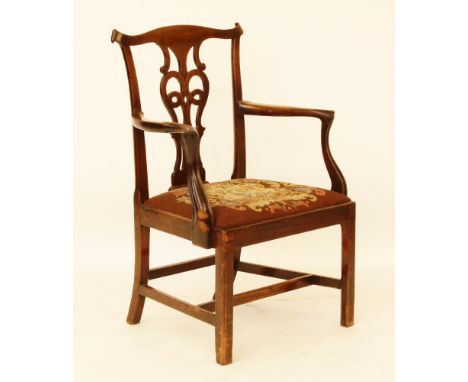 A Chippendale style mahogany elbow chair, with a pierced urn shaped splat, outswept arms and a drop in seat