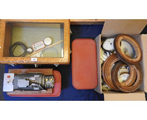 A large quantity of various aneroid barometer parts and spares, to include dials, movements, etc and a vacuum pump and compre