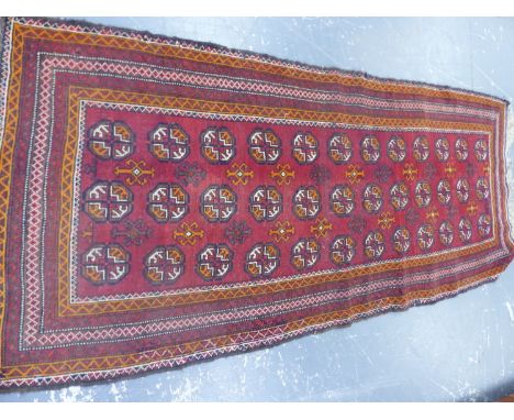 AN AFGHAN BOKHARA RUNNER.   255 x 106cms.