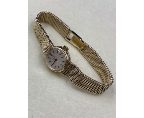 A LADIES 9ct GOLD OMEGA BRACELET WATCH WITH A LADDER CLASP COMPLETE WITH REPAIR WARRANTY CARD DATED 2012 AND SERVICE CASE. GR