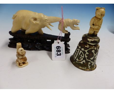 A JAPANESE IVORY GROUP OF AN ELEPHANT HOLDING UP A TIGER WITH ITS TRUNK.   W 15.5cms. A CHINESE BELL WITH IVORY FIGURAL HANDL