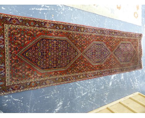 AN ORIENTAL RUNNER OF PERSIAN BIDJAR DESIGN.   250 x 72cms.