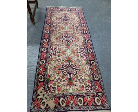 A PERSIAN FLORAL PATTERN SMALL RUNNER.   191 x 75cms.