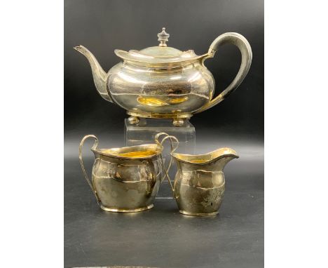 A SILVER HALLMARKED THREE PIECE TEA SET, THE TEAPOT DATED 1919 SHEFFIELD FOR ATKIN BROTHERS, THE SUGAR AND MILK FOR CHARLES E