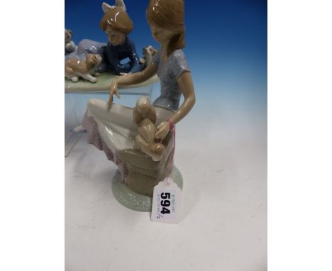 TWO LLADRO GIRL AND PUPPY GROUPS, THE YOUNGER GIRL LYING ON THE GRASS TO PLAY WITH THREE PUPPIES.   W 18cms. THE ELDER GIRL S