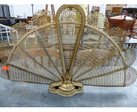 AN EARLY 20tH.C. BRASS PEACOCK FAN FORM FIREGUARD ON CAST BRASS BASE.   H.70cms.