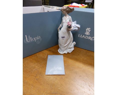 A BOXED AND CERTIFICATED LLADRO FIGURE OF UTOPIA, THE LADY IN A WIND BLOWN LONG DRESS HOLDING A VASE OF FLOWERS.   H 31cms.