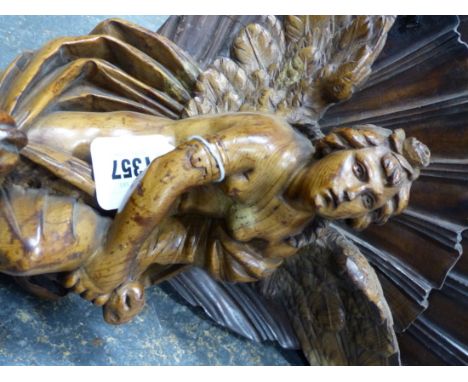 A FRUITWOOD CORNER BRACKET, THE UNDERSIDE OF THE SHELF CARVED WITH TWO FAN SHAPES ABOVE A SCANTILY DRAPED ANGEL WITH A ROSE I