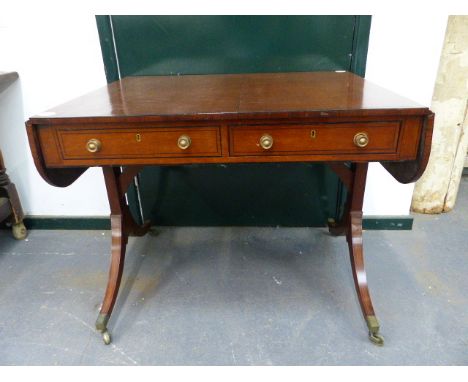 A GEORGIAN INLAID MAHOGANY SOFA TABLE WITH APRON DRAWERS ON BRASS CAP CASTERS.