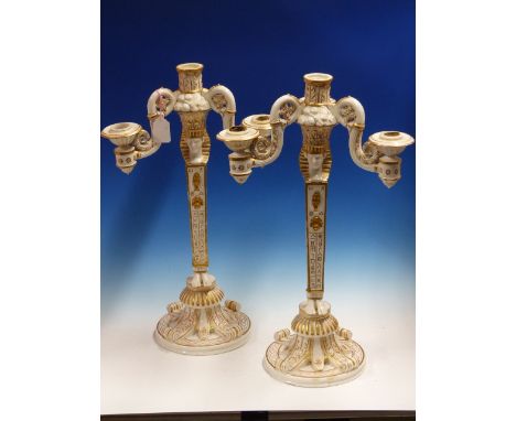 A PAIR OF GILT WHITE NAPLES PORCELAIN FOUR LIGHT CANDELABRA INSPIRED BY NAPOLEON'S EGYPTIAN CAMPAIGN, THE BRANCHES SUPPORTED 