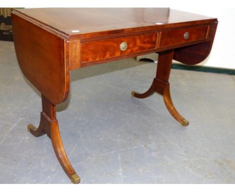 A GOOD QUALITY REGENCY STYLE MAHOGANY SOFA TABLE WITH LINE INLAY DECORATION ON BRASS CAP CASTERS.   154 x 58 x H.75cms.