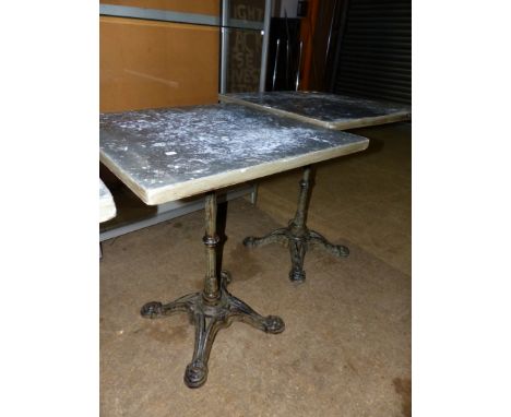 A PAIR OF VINTAGE CAFE TABLES WITH CAST IRON BASES AND ZINC WRAPPED PINE TOPS.   59 x 59 x H.73cms.