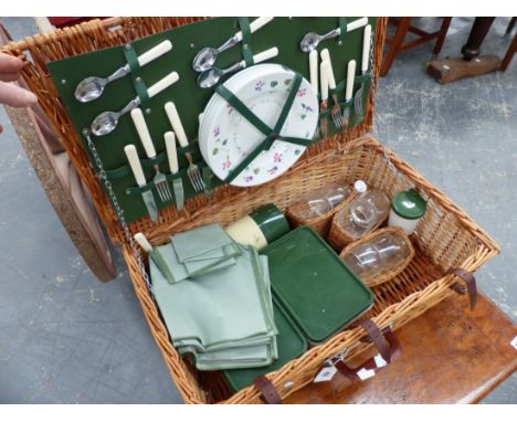 A WICKER PICNIC HAMPER.