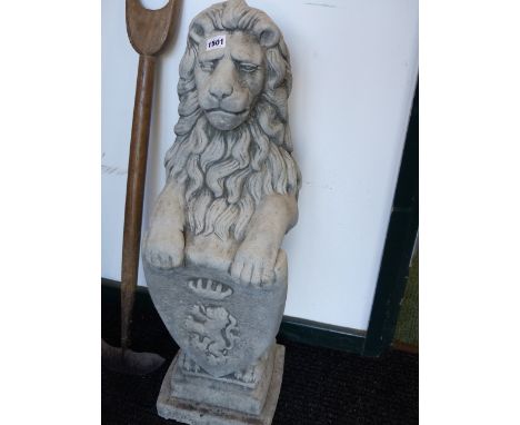 A PAIR OF GATEPOST FINIAL FIGURES OF LIONS BEARING CRESTED SHIELDS.   H.82cms.