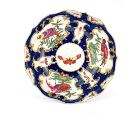 A Worcester scale blue bowl, square mark, circa 1770, double ogee form with serpentine rim, painted with fancy birds, and ins