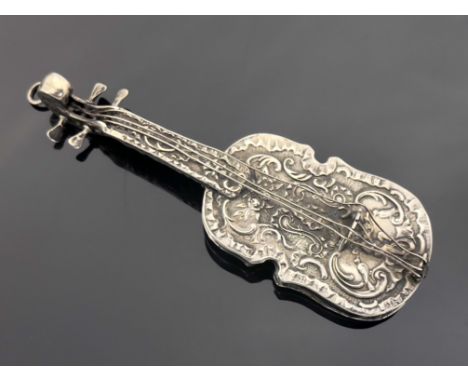 A Continental novelty silver scent flask, 19th century, modelled as a violin, embossed in relief with foliate scroll design, 