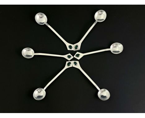 A set of six Arts and Crafts white metal and gem set teaspoons, circa 1905, the planished circular bowls with pointed rat tai